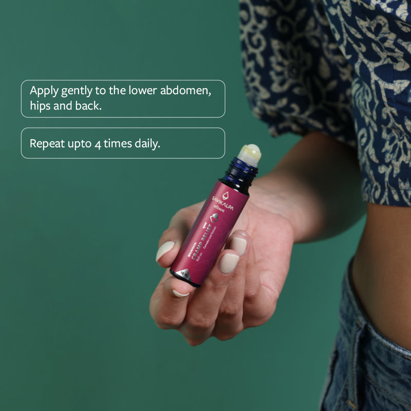 A woman about to apply Shunyata Cramp Relief to her abdomen to soothe her period pains with usage instructions alongside it. 