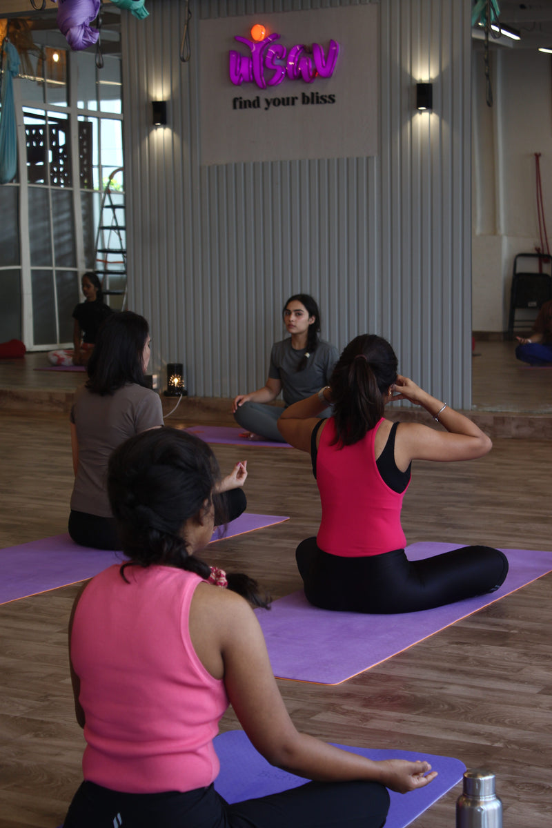 People practicing yoga at Utsav