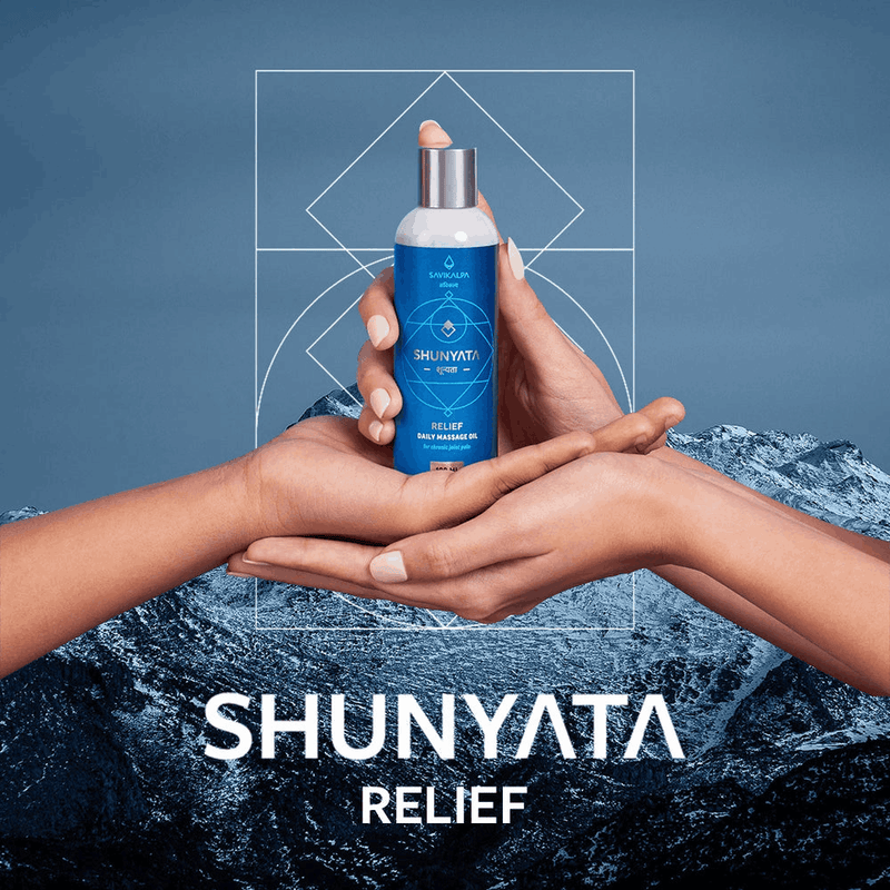 The banner image for Shunyata Relief, where Savikalpa's natural massage oil is held in two hands against a serene landscape.