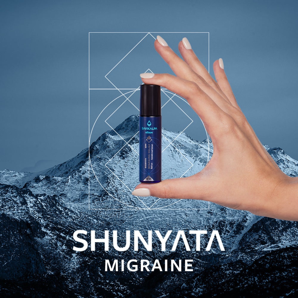 Shunyata Migraine Relief Roll-On product held against a mountain backdrop